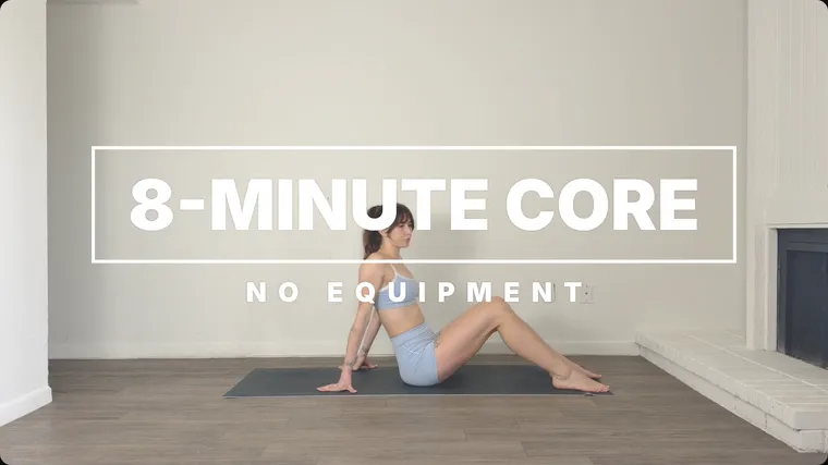 An intro graphic in the Frame style over the start of a core workout: 8-MINUTE CORE in a white frame with NO EQUIPMENT under it, over a woman sitting on a mat in a bright room.