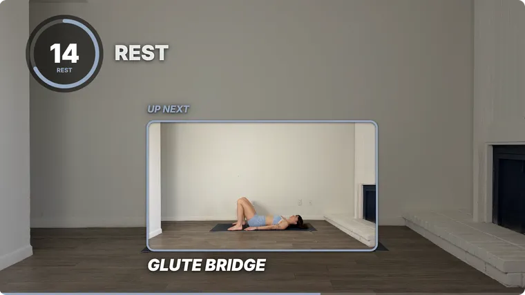 A rest on screen: the ring timer and REST at the top left, and a large UP NEXT window in the middle playing Glute Bridge, with its name underneath.