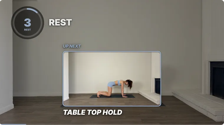 A rest in a finished SweatCut video: the ring timer and REST at the top left, and an UP NEXT window in the middle playing Table Top Hold.